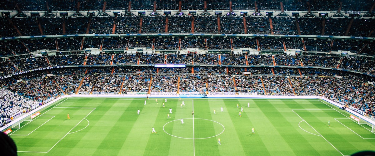 足球转会市场动态：一名球员身穿新俱乐部球衣与主席握手的签约仪式现场